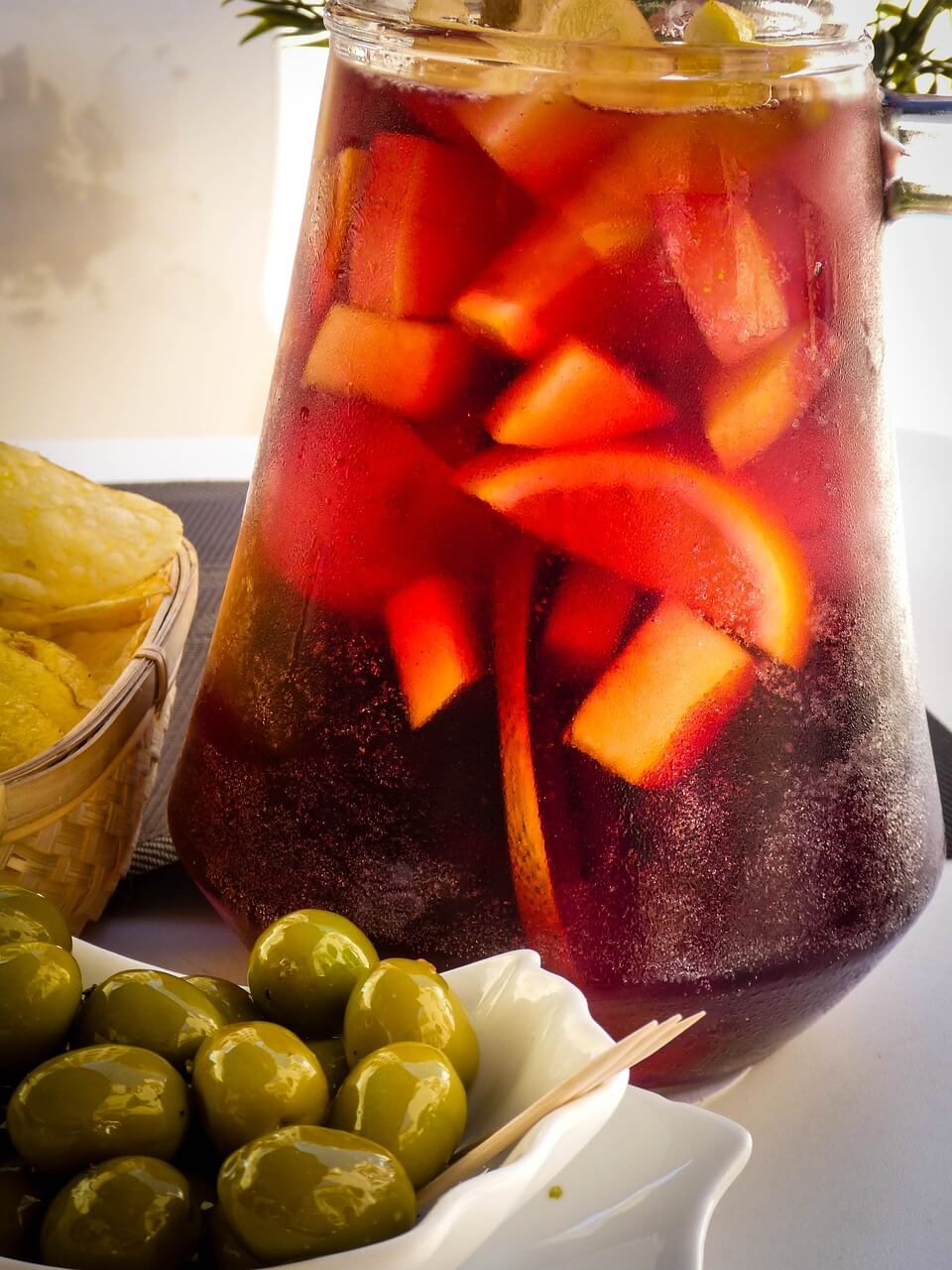 Table with Spanish tapas, olives, and red sangria